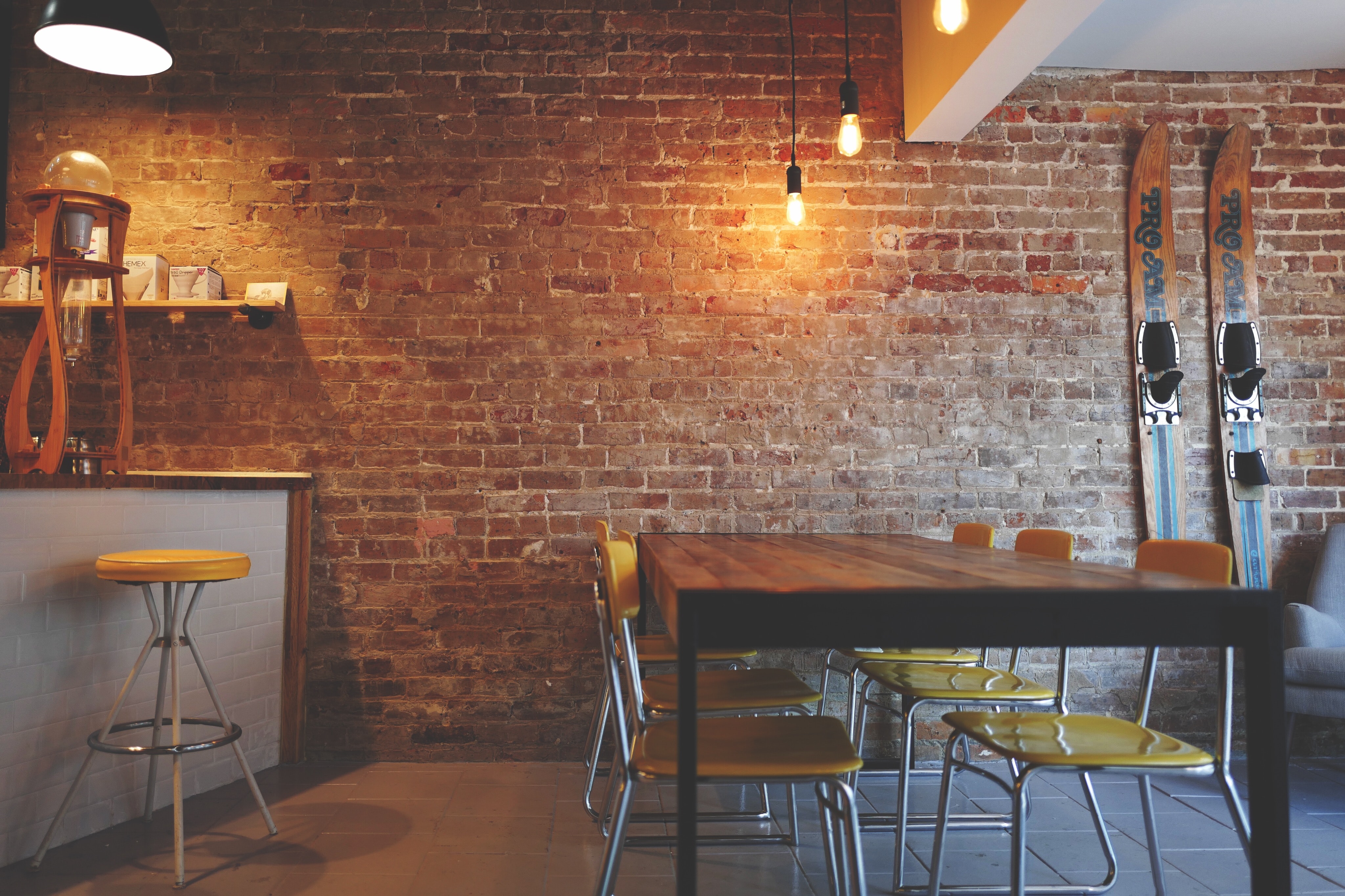 Face-free coffee shop interior with a wooden table and indoor lounge details.